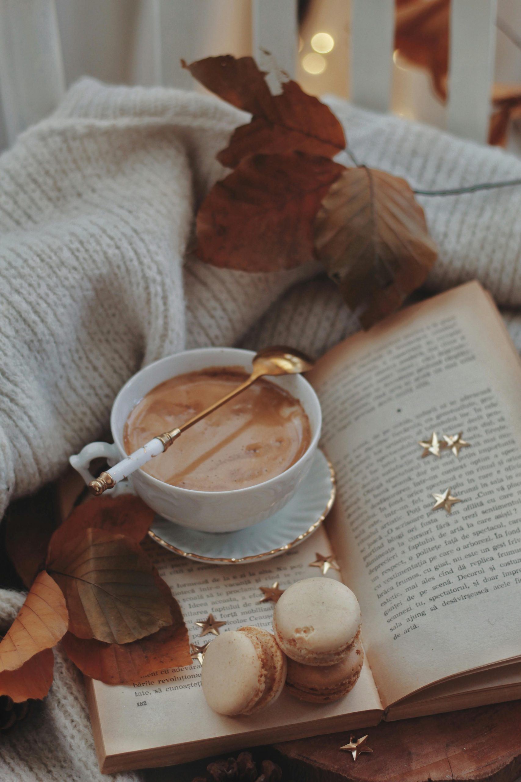 Cozy fall living room with candlelight, knit throw, and a latte