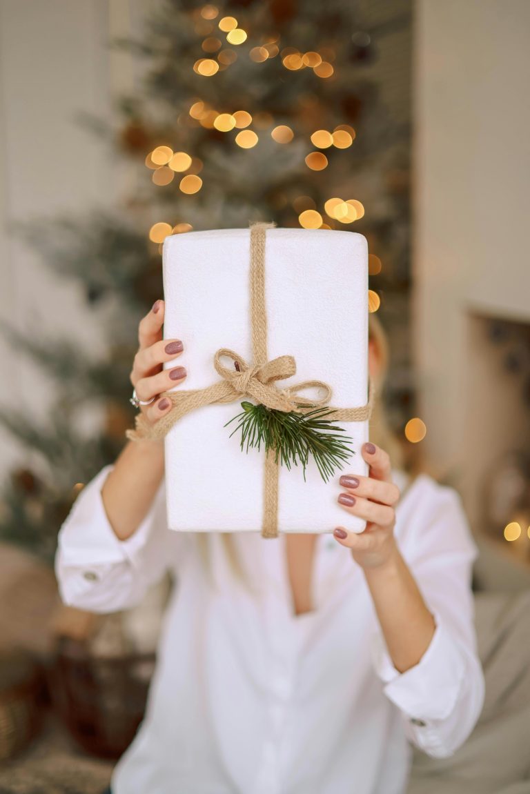 10 best Amazon Christmas gifts for women 2025 including cozy loungewear, UGG slippers, Owala water bottles, Bose headphones, shower oil, blankets, and wellness tech.