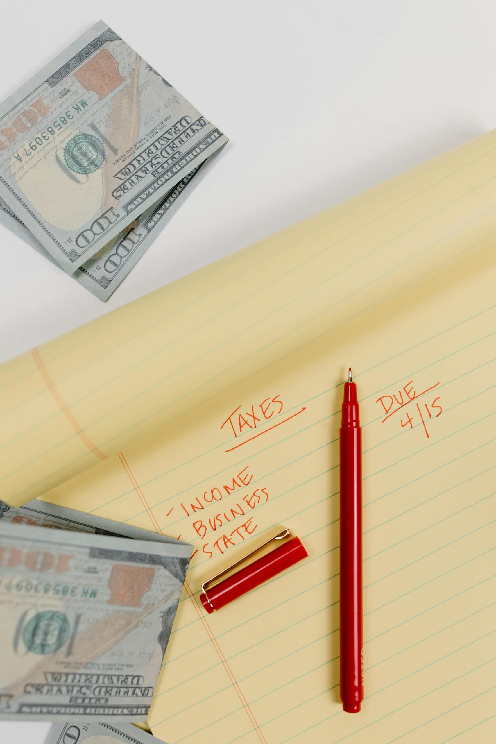 Organized tax documents, calculator, and money on desk during tax preparation