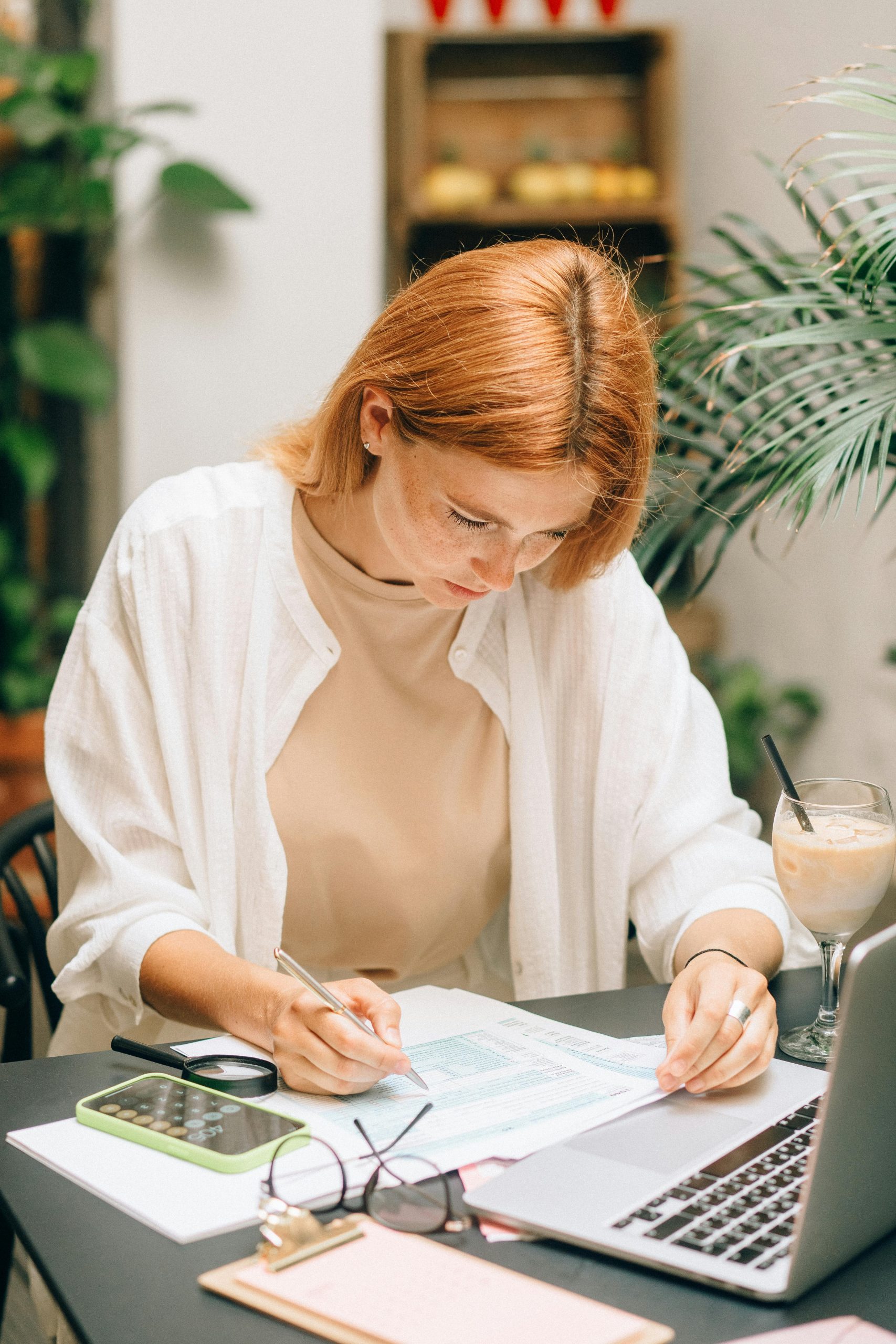 Woman organizing finances and planning week during Sunday reset routine