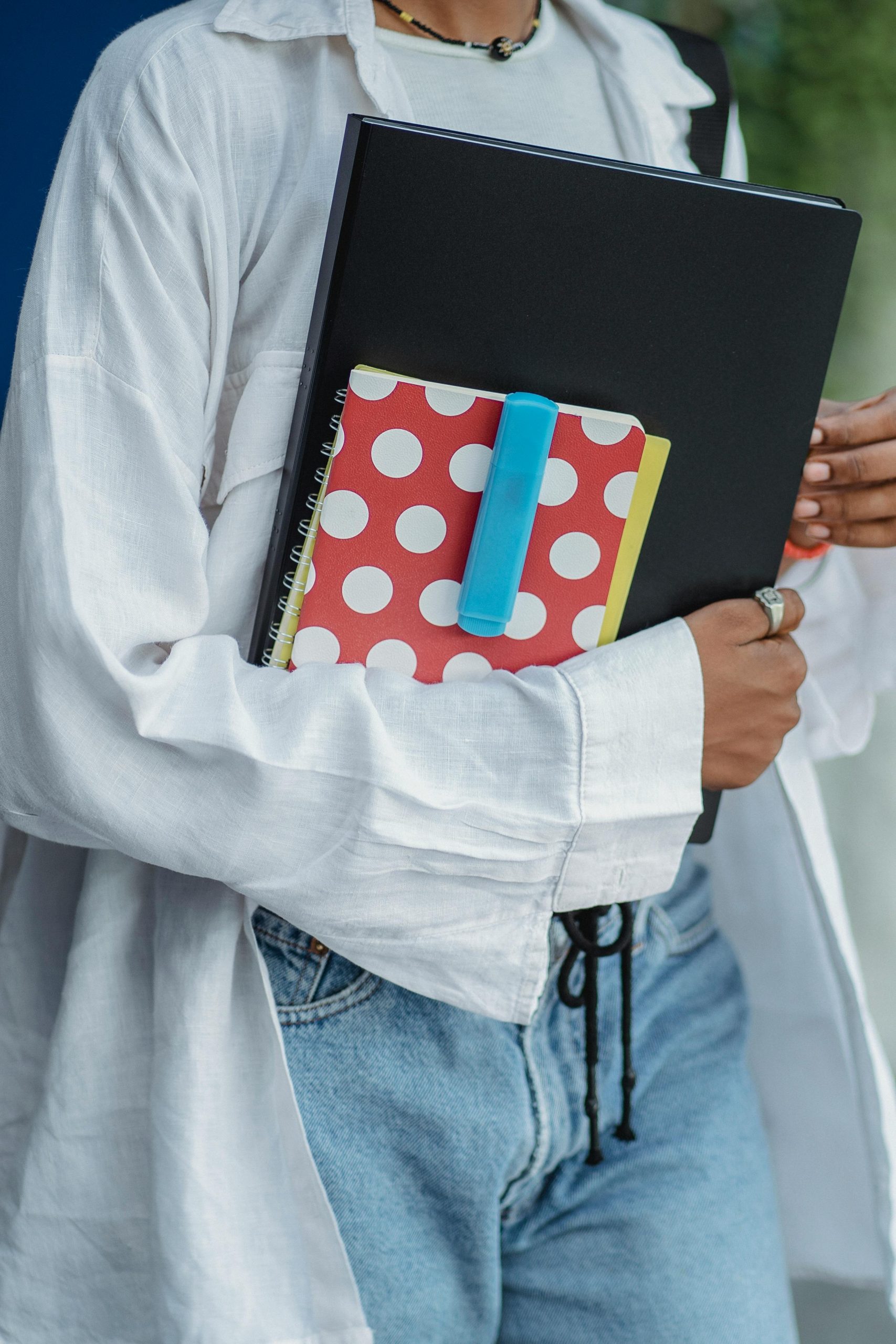 Woman holding organized folders and paperwork for a family emergency binder