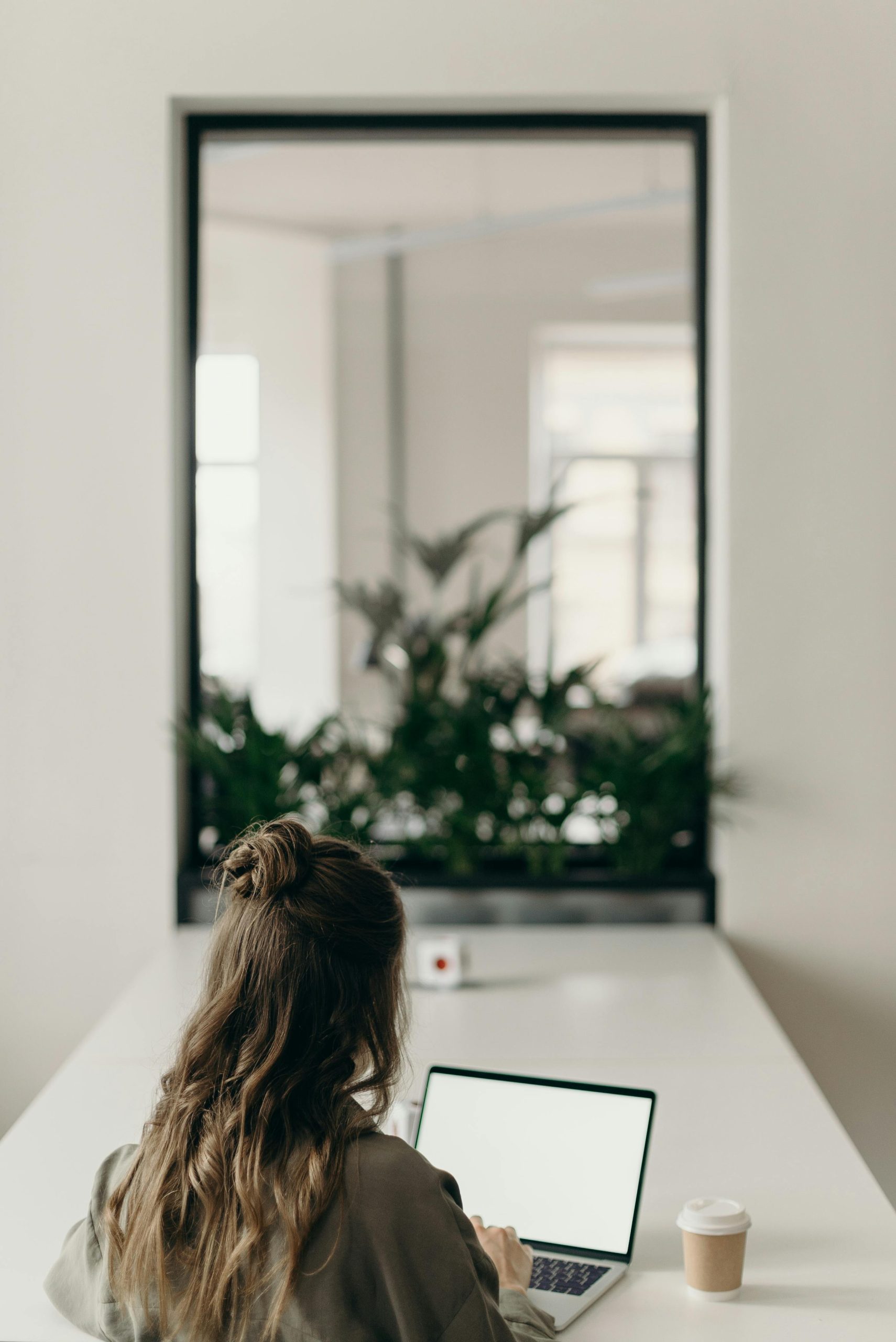 Woman planning weekly routine in planner during a Sunday reset routine
